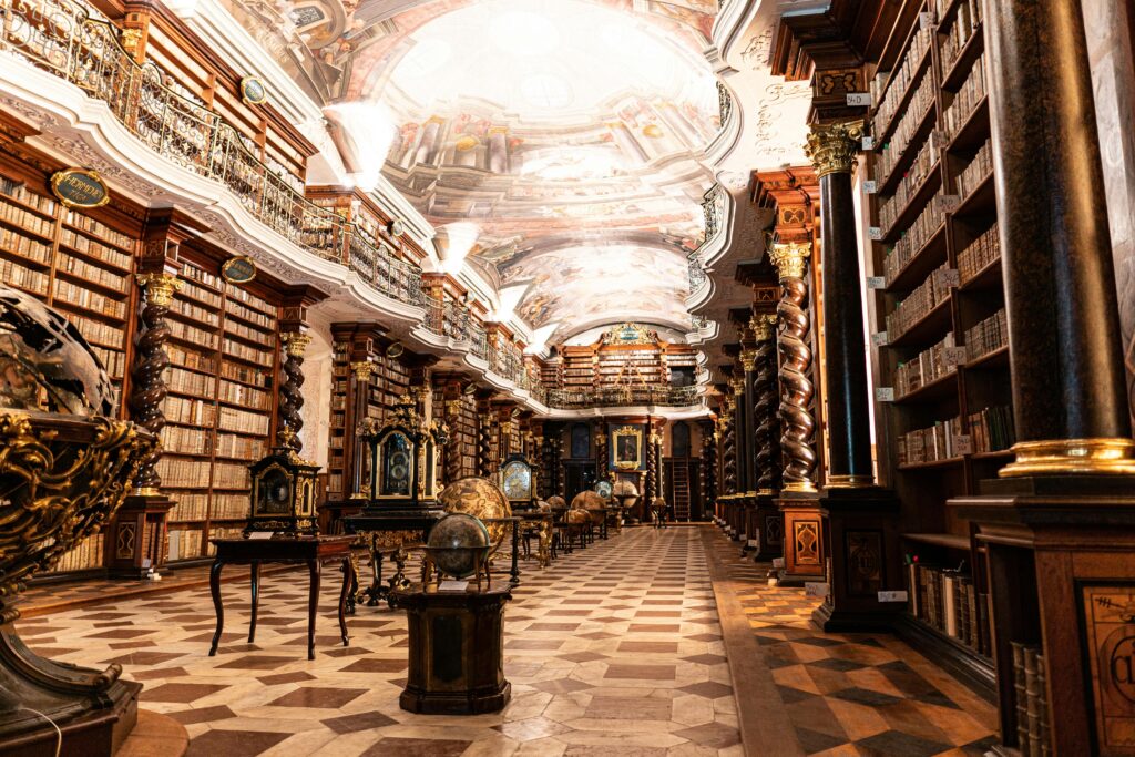 Clementinum Baroque Library in Prague with historic bookshelves and painted ceiling