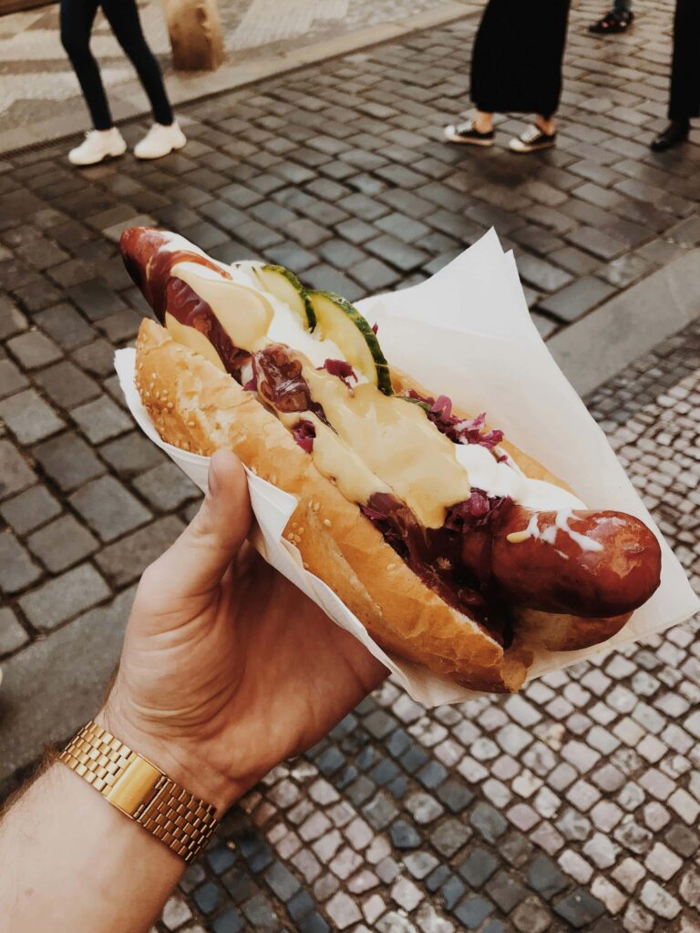 Food & Drinks in Prague – traditional Czech street food sausage with mustard and pickles