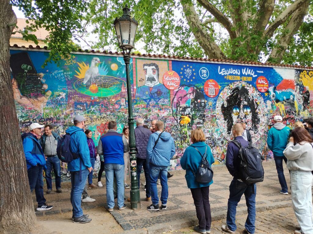 Colorful Lennon Wall in Prague covered with graffiti and Beatles inspired art