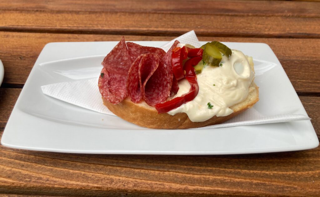 Obložené chlebíčky Czech open sandwich with salami, egg, pickles, and creamy spread – traditional snack in Prague Food Guide