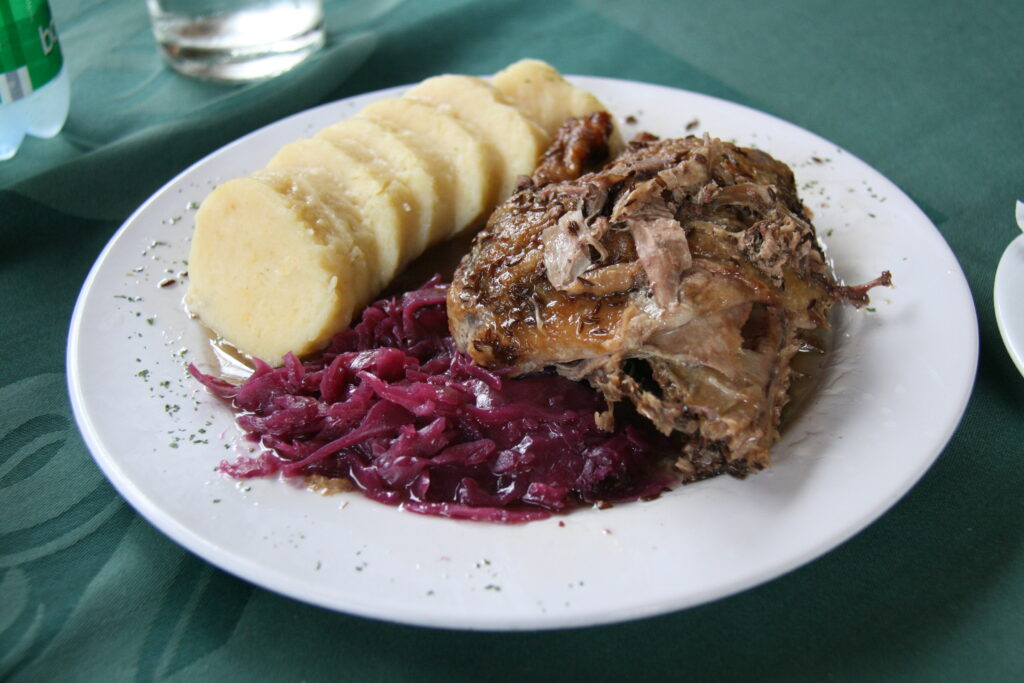 Pečená kachna (roast duck) with bread dumplings and red cabbage – traditional Czech dish in Prague Food Guide