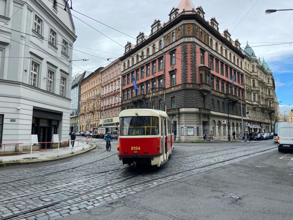 Prague tram in city street showing affordable public transportation options and travel costs for visitors