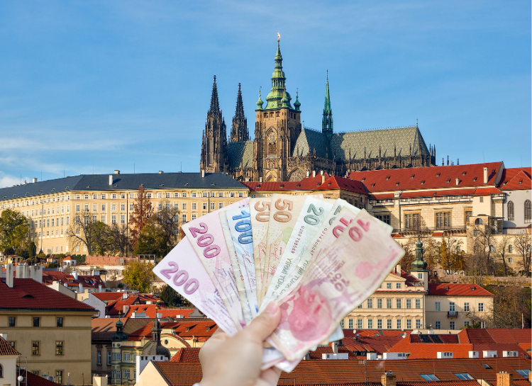 Prague trip cost concept with Euros banknotes and Prague Castle in the background