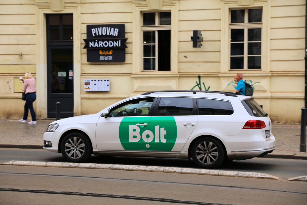 Bolt ride-hailing car parked on a street in Prague near a building entrance
