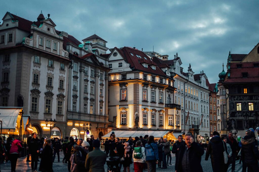 Crowded Old Town Square in Prague filled with tourists and busy streets, showing peak tourist conditions to avoid