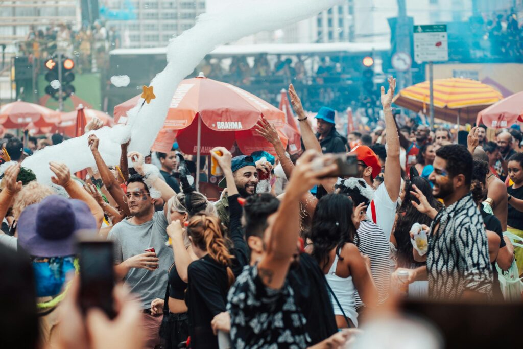 Crowd of people partying and celebrating in a busy street festival setting