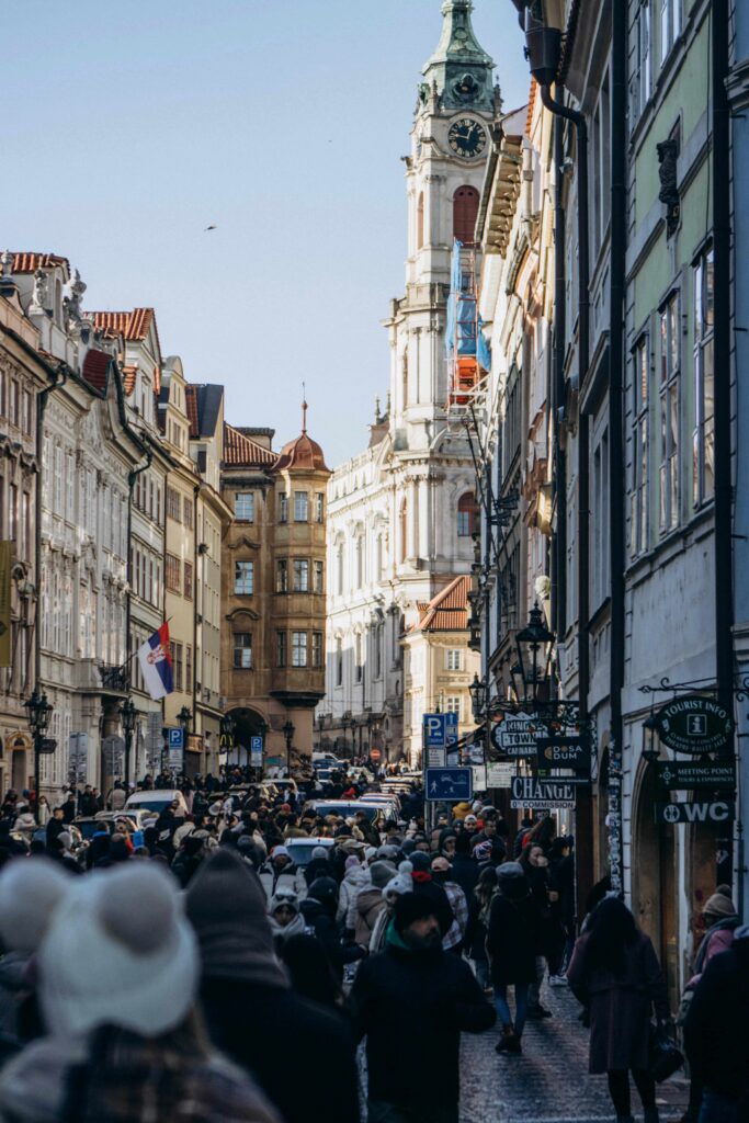 Crowded street in Prague Old Town filled with tourists, showing busy conditions travelers should avoid during peak hours