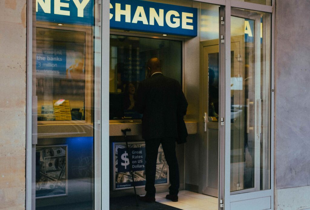 Tourist exchanging money at a currency exchange office in Prague, one of the common things to avoid in Prague due to misleading rates