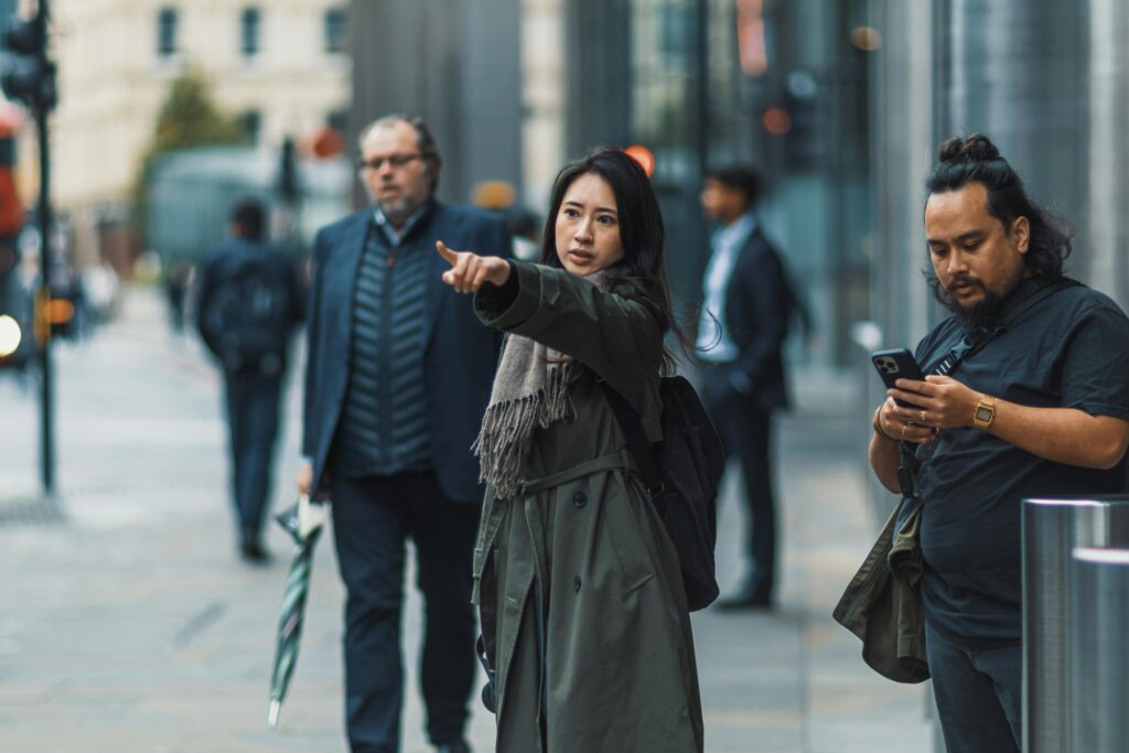 Person asking for directions on a busy street while others are distracted