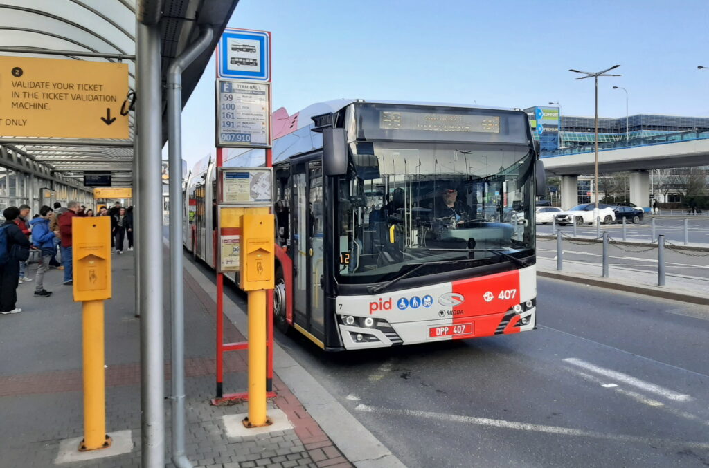 Public bus 119 at Prague Airport bus stop near Terminal 1 with passengers waiting