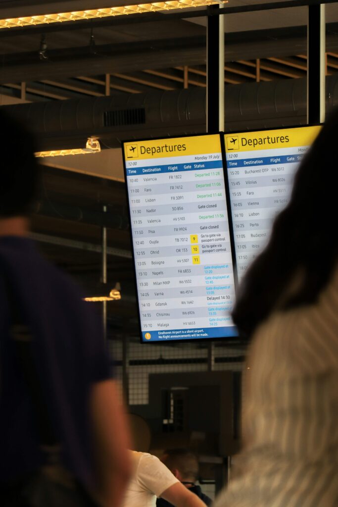 Prague Airport departures board showing flight times and gates inside the terminal