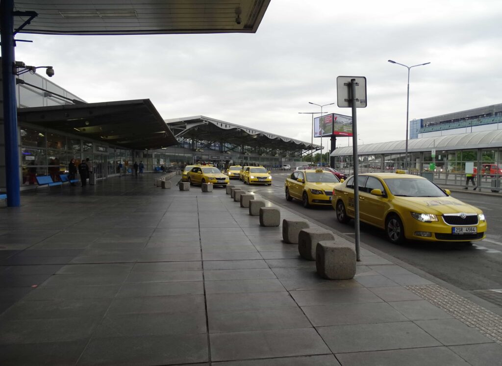 Official yellow taxis lined up outside Václav Havel Airport Prague Terminal 1 waiting for arriving passengers