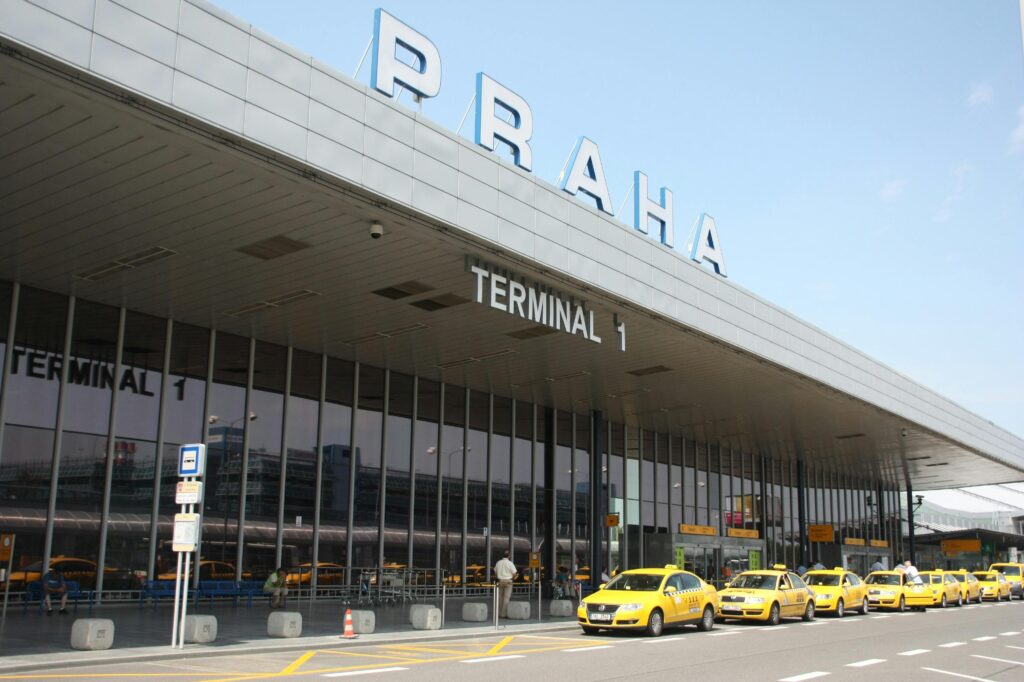 Taxi area outside Prague airport terminal with vehicles waiting for passengers