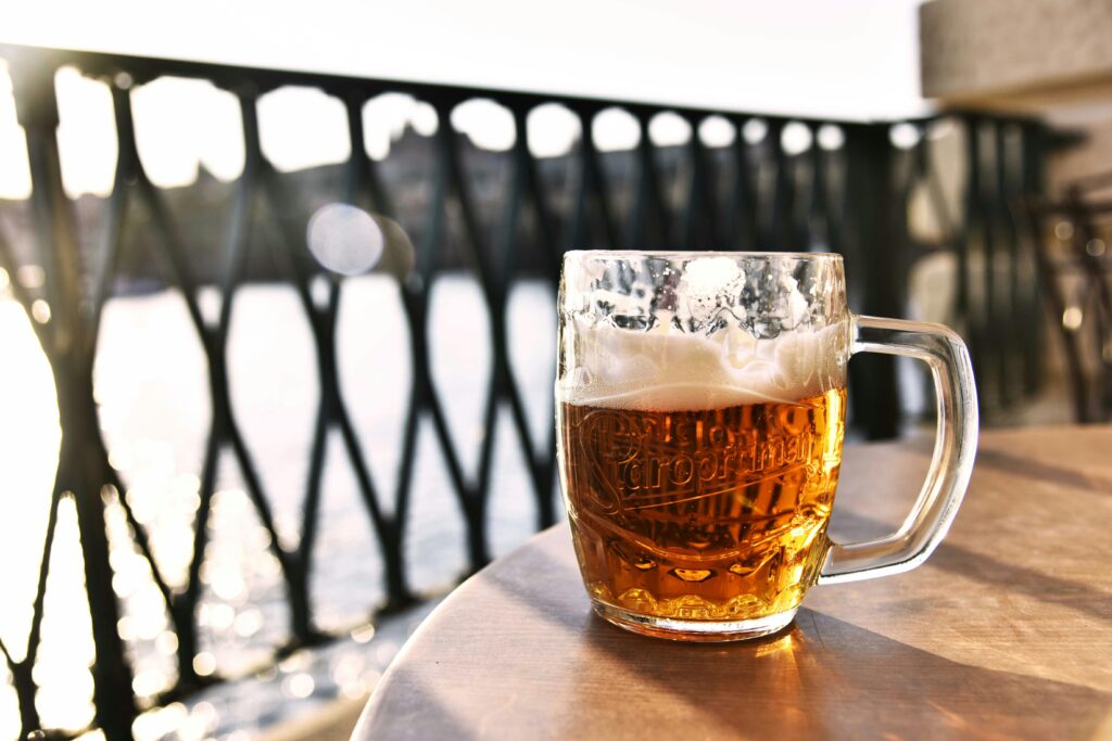Glass of Czech beer on a table at an outdoor café in Prague