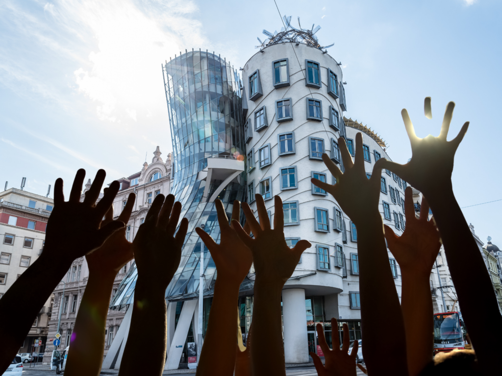 Prague Dancing House with raised hands symbolizing freedom and democratic change in Prague