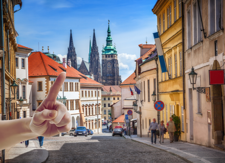 Things to avoid in Prague shown through a scenic street with historic buildings and Prague Castle in the background