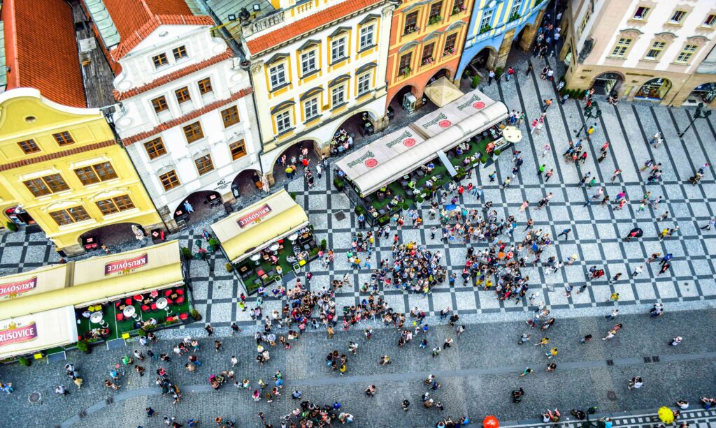 Crowded restaurants in Prague Old Town filled with tourists, typical example of tourist trap dining areas to avoid