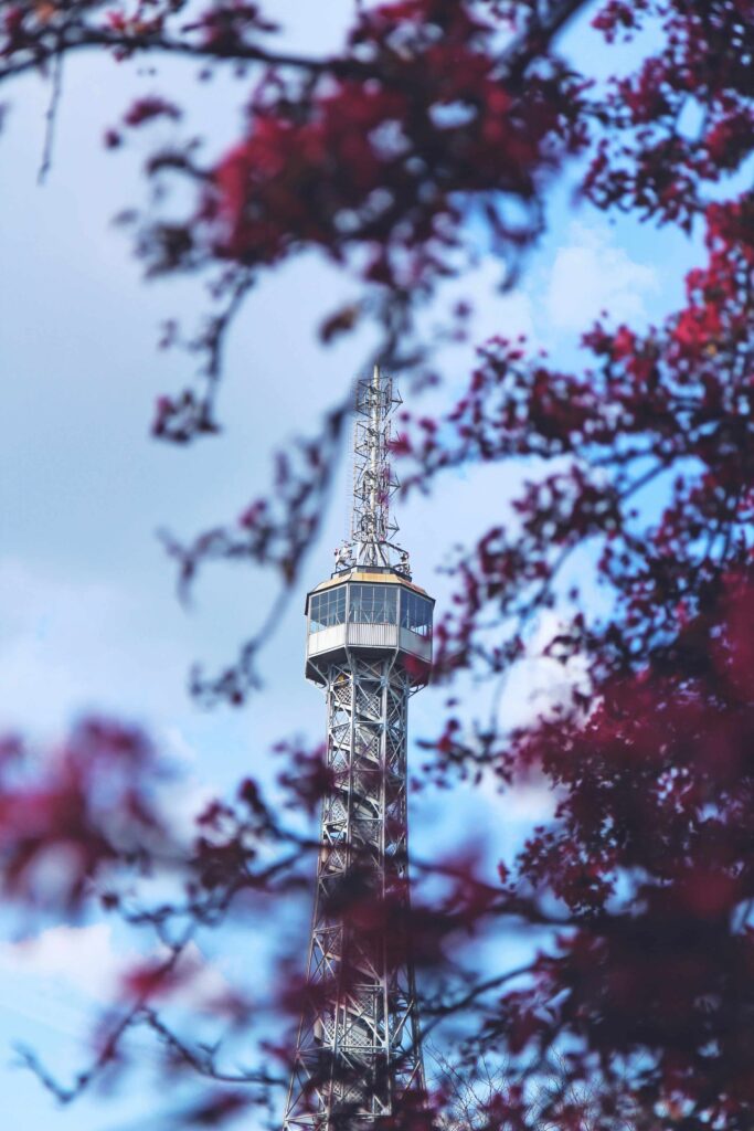 Petřín Lookout Tower surrounded by spring trees and blue skies in Prague – Prague Towers