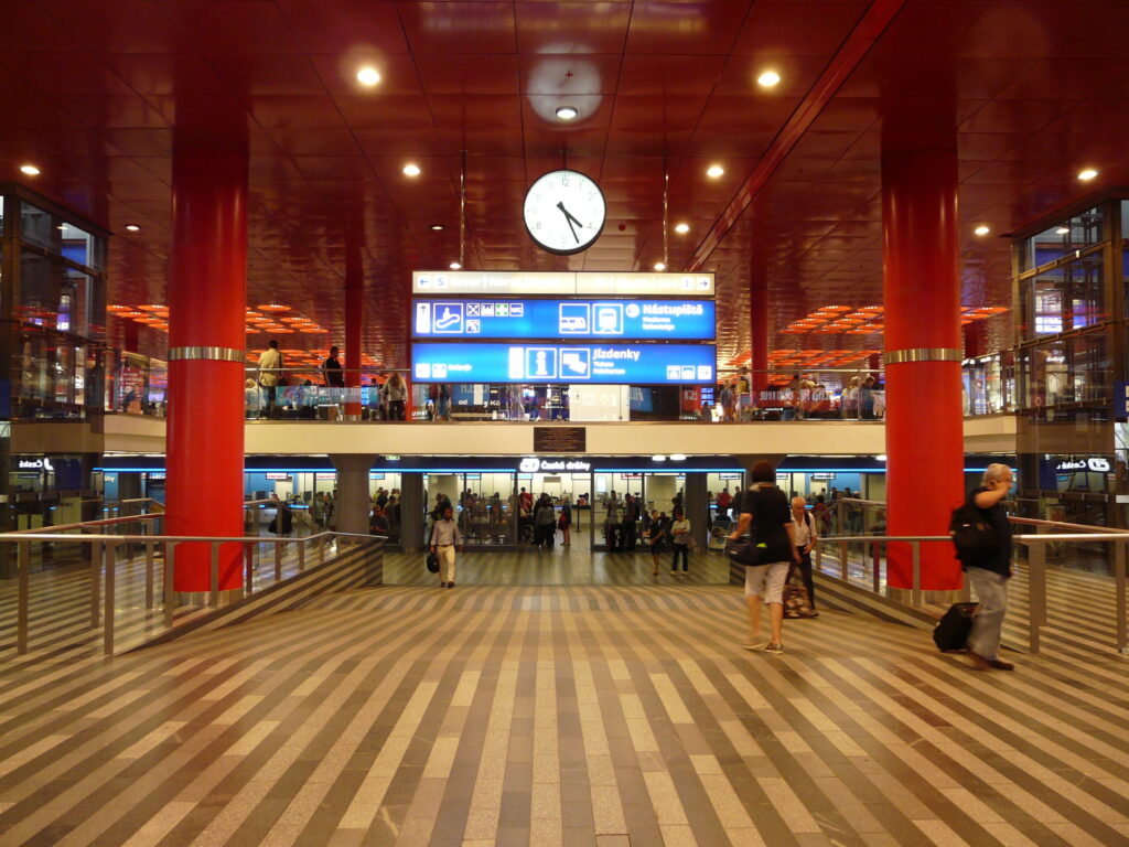 Interior hall of Prague Main Station with platform signs and passenger navigation in Prague