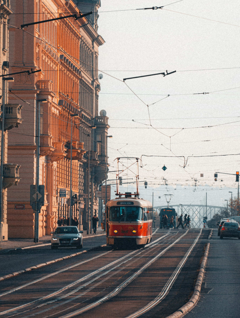 Prague tram passing through a historic Old Town street with classic architecture