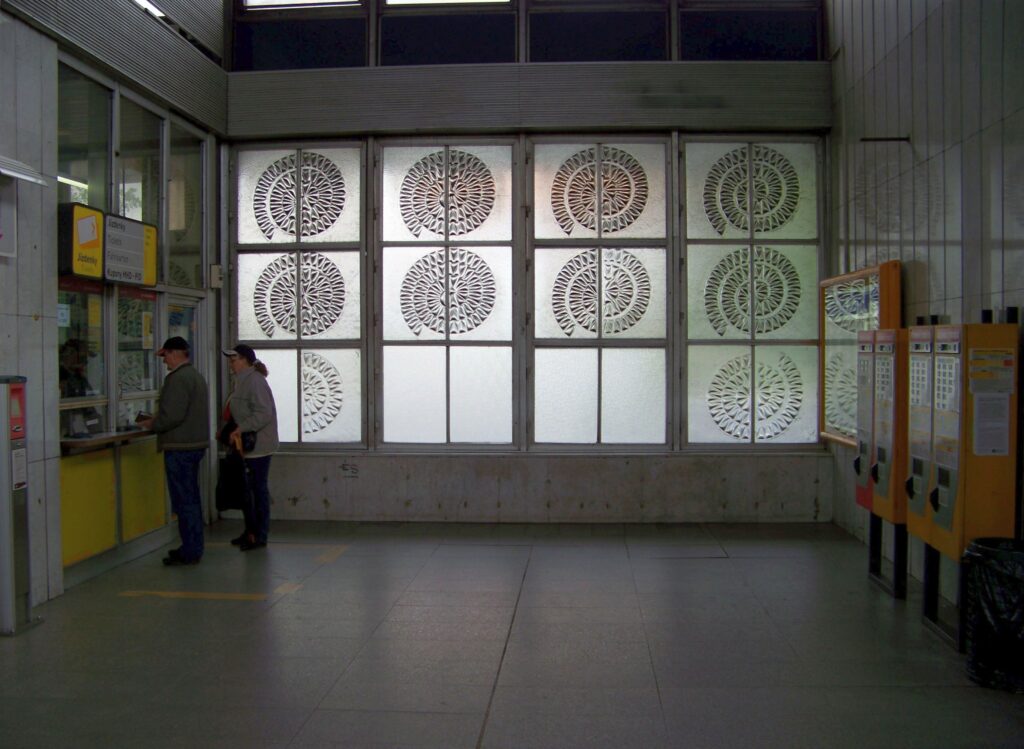 Ticket machines and ticket office inside Prague metro station where passengers must buy tram tickets before boarding