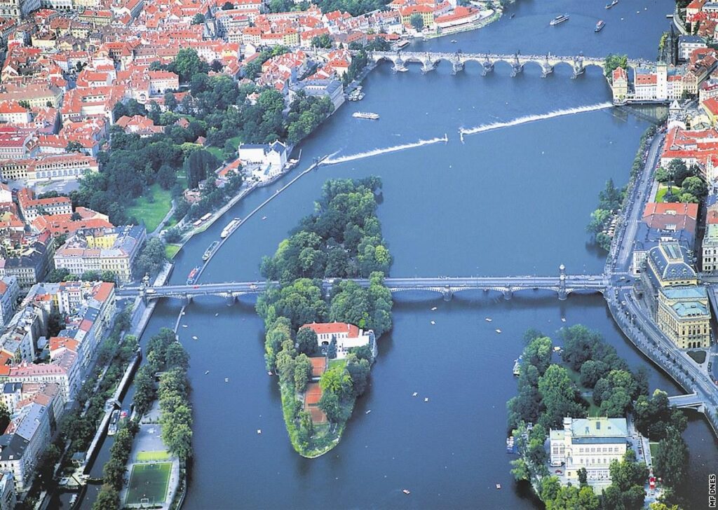 Aerial view of Střelecký Island surrounded by Prague Bridges and the Vltava River in the heart of Prague.