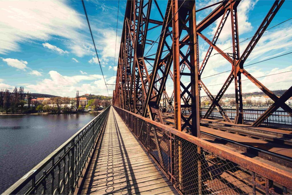 Among Prague Bridges, the Vyšehrad Railway Bridge stands out for its iconic steel framework and industrial character.