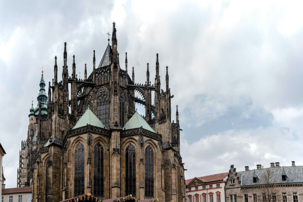 St. Vitus Cathedral at Prague Castle under cloudy skies in Prague, Czech Republic – featured in a guide about Prague Castle opening hours in 2026, including castle grounds, gardens, interior schedules, winter hours, and the best morning visiting times.