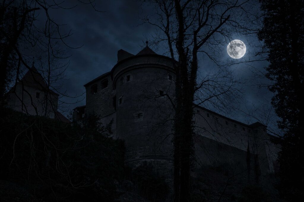 Dalibor Tower at Prague Castle under a moonlit sky, the historic prison linked to the legend of the knight whose ghostly violin still echoes through one of the most haunting dark stories in Prague