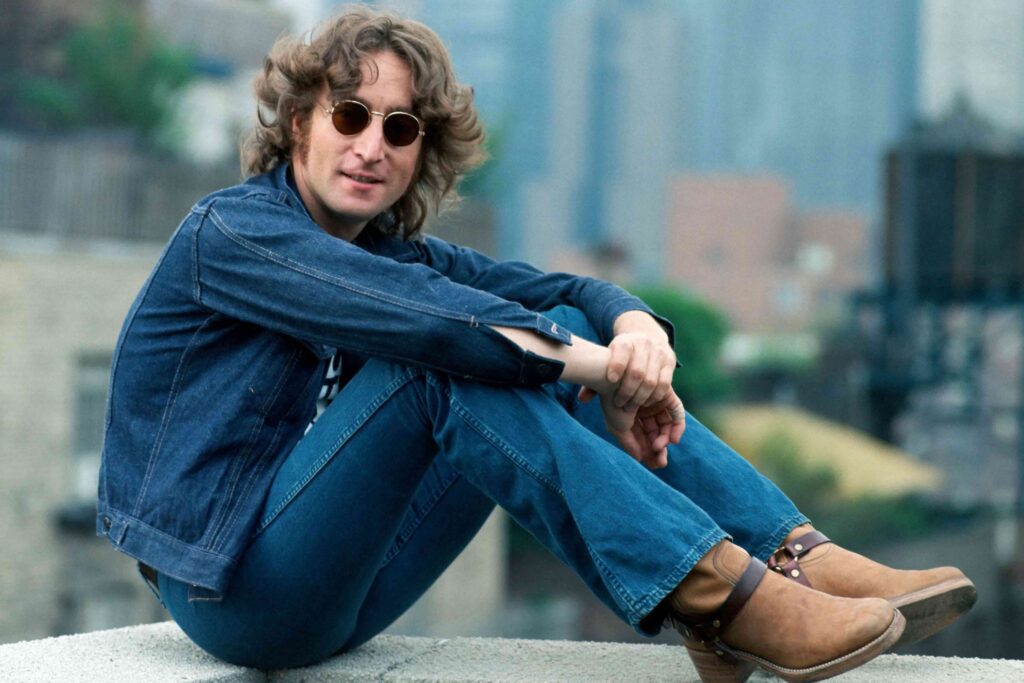 Famous People in Prague: Portrait of John Lennon wearing round sunglasses and a denim jacket