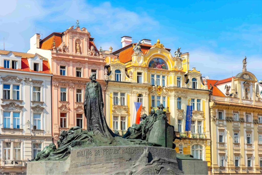 Jan Hus Monument in Old Town Square Prague, with the historic Old Town buildings in the background, symbolizing Czech resilience and one of the most significant dark stories in Prague.