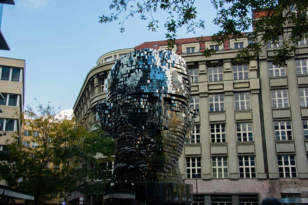 Prague Architecture: Kafka Head, a rotating stainless-steel sculpture by David Černý outside Quadrio in Prague