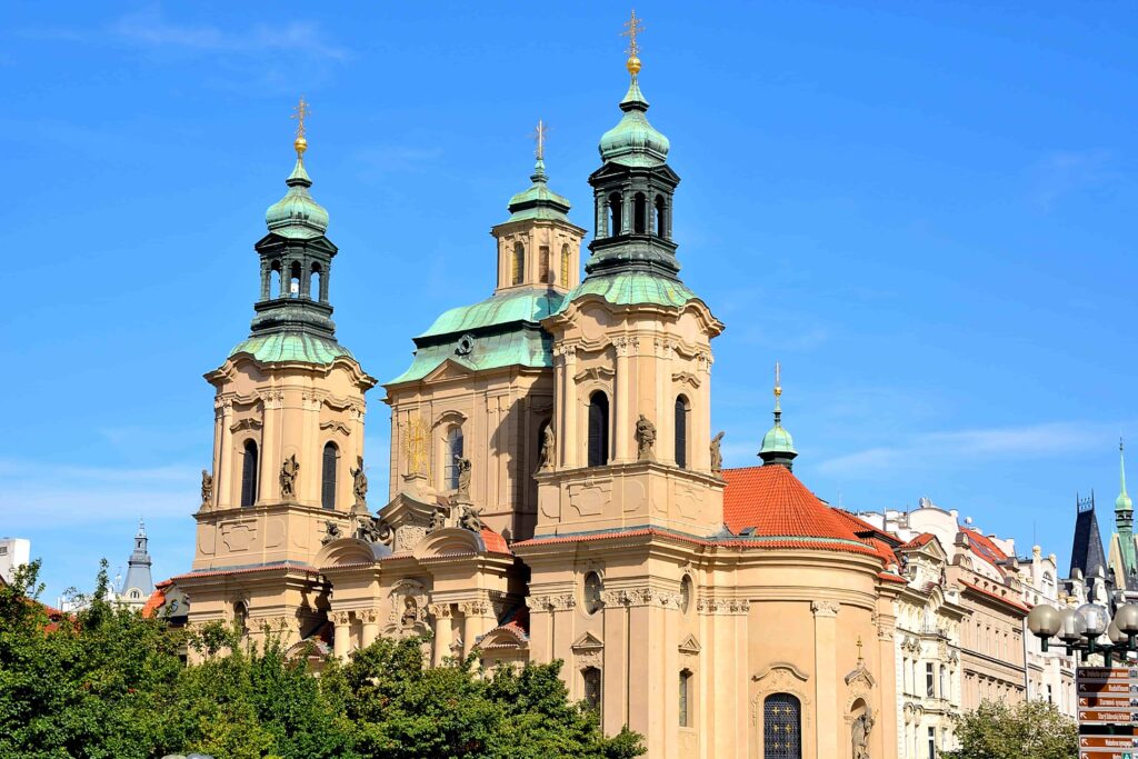 Prague Architecture – St. Nicholas Church, a Baroque masterpiece in Lesser Town with twin towers, a grand green copper dome, and ornate architectural details