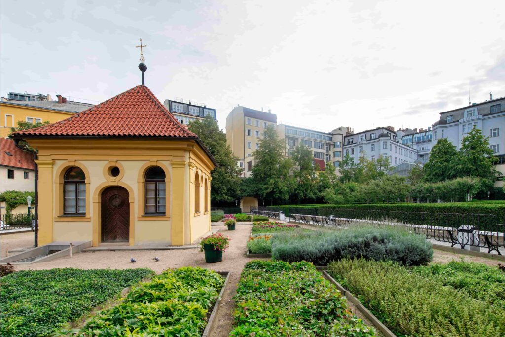 Franciscan Garden, one of the most peaceful Prague Parks, featuring a historic chapel, colorful flower beds, and landscaped greenery in the city center