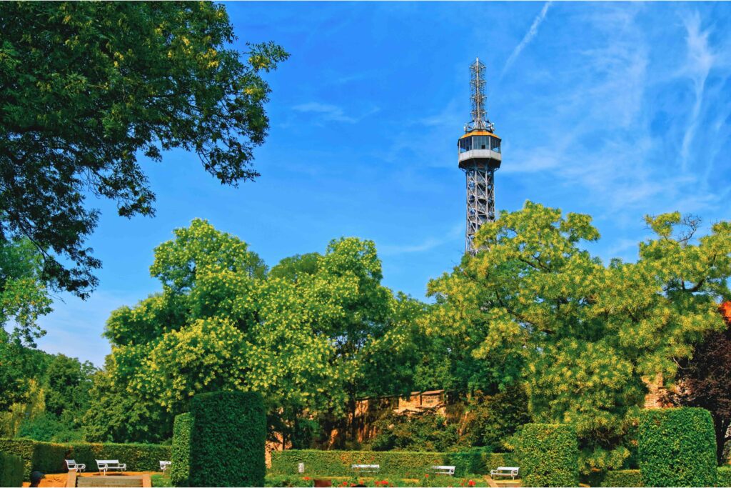 Petřín Lookout Tower rising above lush greenery in one of Prague’s most beautiful parks on a sunny day