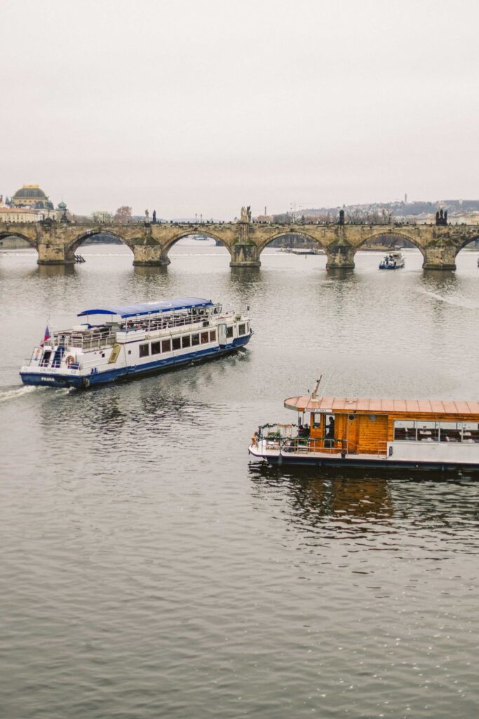 Prague Rivers with Charles Bridge and sightseeing boats on the Vltava River