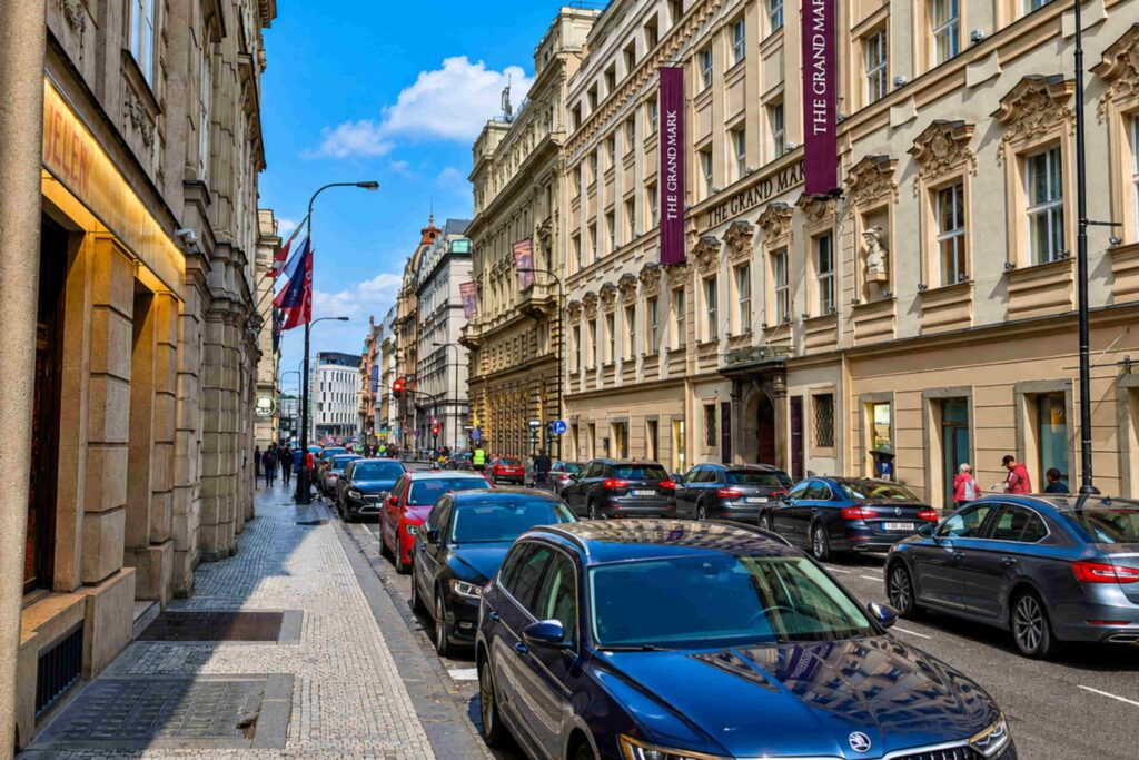 Prague Streets – Hybernská Street featuring elegant historic buildings, boutique hotels, tree-lined sidewalks, and a lively atmosphere in central Prague