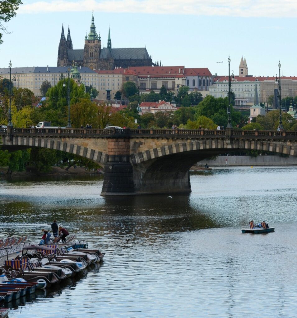 Prague Water Activities with pedal boats on the Vltava River beneath Charles Bridge
