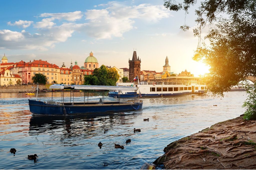 Prague water activities on the Vltava River with boats and Prague skyline