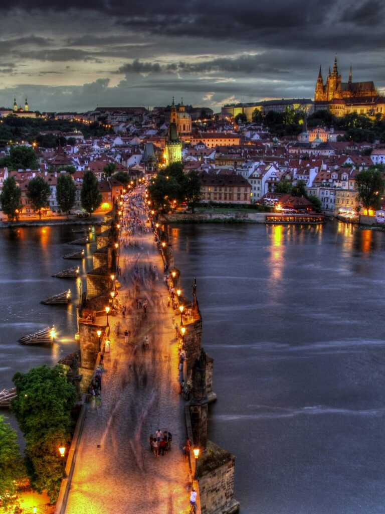 Prague Night Activities with a view of Charles Bridge and Prague Castle at dusk