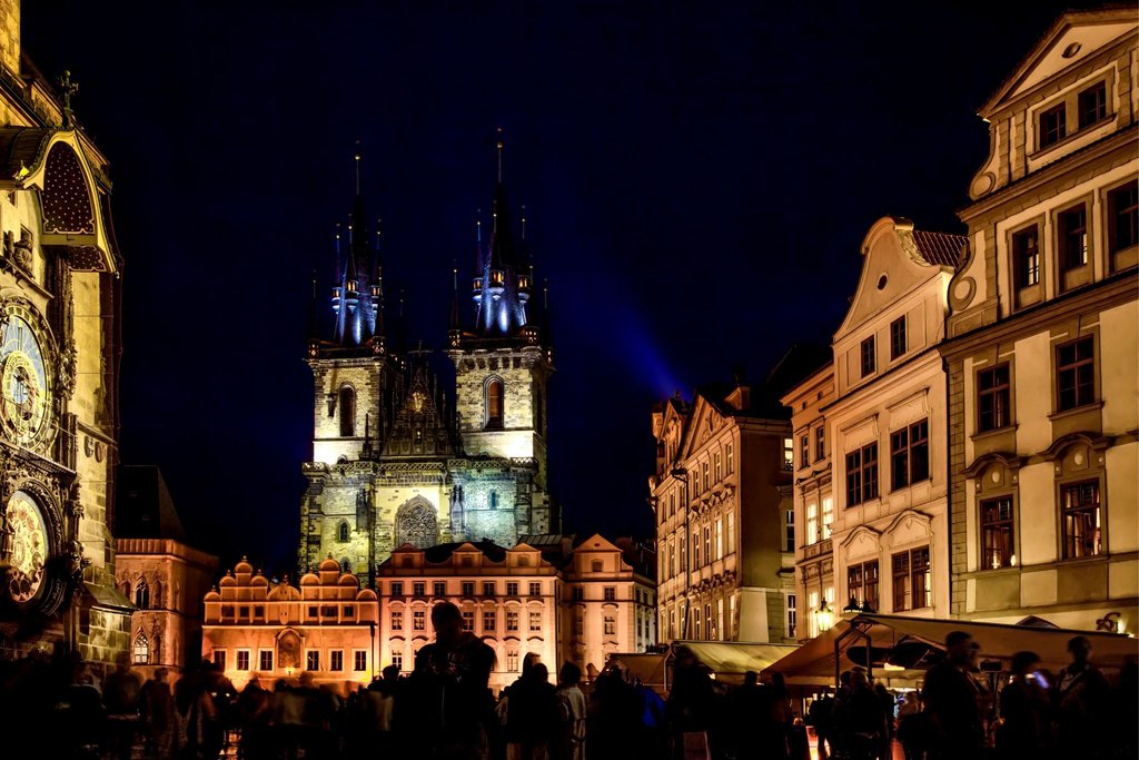 Prague Night Activities in Old Town Square with the illuminated Church of Our Lady before Týn and historic buildings at night