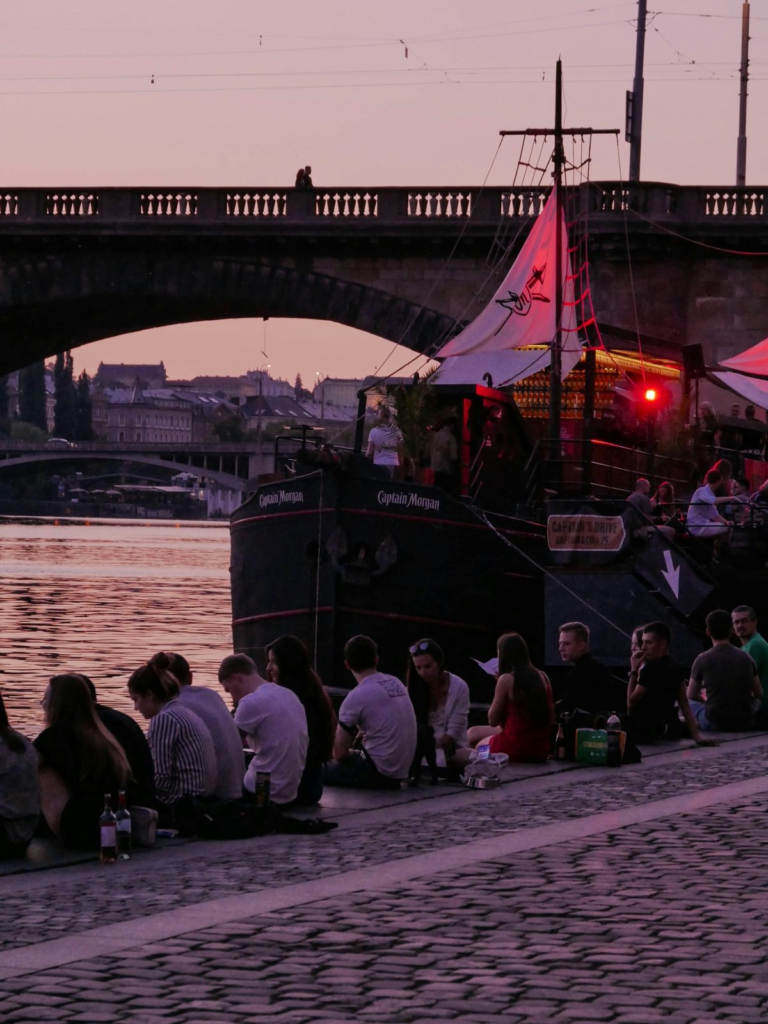 Prague Night Activities along the Vltava River with a riverside party boat at sunset