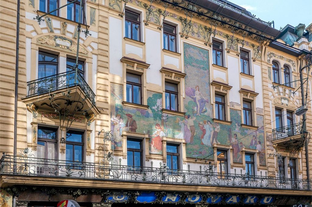 U Nováků building in Prague showcasing Art Nouveau Prague architecture with ornate balconies, floral decoration and a large mosaic façade